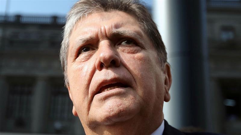 In this file image, former Peruvian president Alan Garcia speaks to the media as he arrives at the National Prosecution office in Lima, Peru in March 2018 [File: Guadalupe Pardo/Reuters]