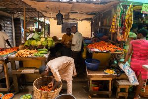 People buy and sell food at the Illaje market, in Bariga, Lagos. [Benson Ibeabuchi/AFP]